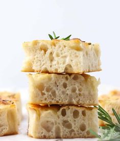 three pieces of bread stacked on top of each other with rosemary sprigs in the background