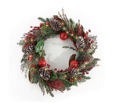 a christmas wreath with pine cones and red berries