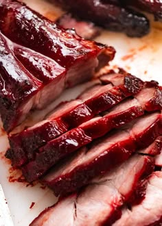 sliced meat on a cutting board with ketchup drizzled over it