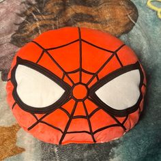 a cake shaped like a spider man on top of a bed covered in frosting