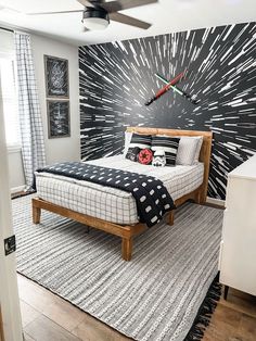 a bedroom with black and white decor on the wall