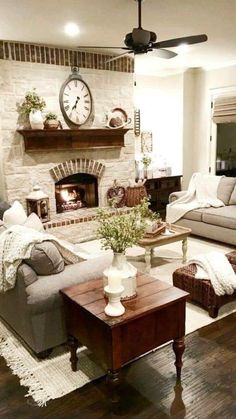 a living room filled with furniture and a fire place in the middle of the room