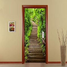 an open door with stairs leading up to the forest and trees on both sides, in front of a vase full of flowers