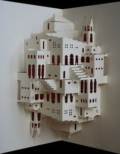 a paper model of a building with red and white buildings on it's sides