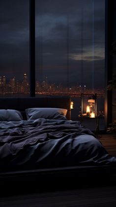 a bed sitting in front of a window next to a night sky filled with lights