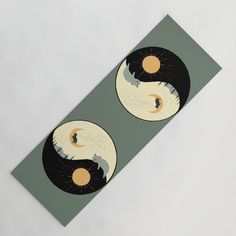 two yin - yang circles with the sun and moon in them on a green background