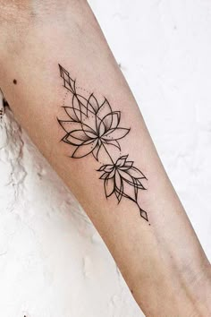 a woman's arm with a tattoo on it that has a flower in the middle