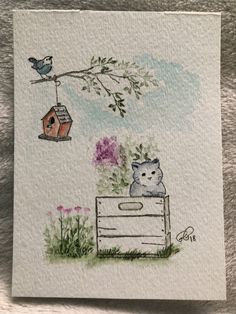 a drawing of a cat sitting on top of a box next to a birdhouse