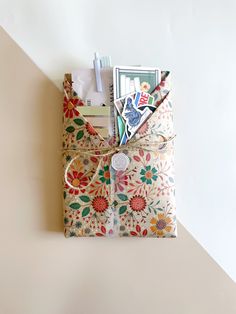 an open gift bag sitting on top of a white table next to a pen and paper