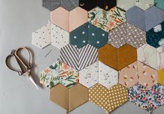 a bunch of hexagons that are sitting on a table with some scissors