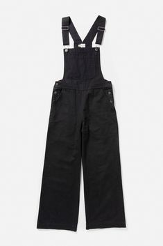 The Roscoe overall is an update on the classic workwear staple featuring a high waist and wide leg, slit pockets at the hips, and a patch pocket. Fabric is a classic cotton canvas twill with a nice texture. A bit of stretch provides an easier fit, though it does sit snugly at the waist. 97% Cotton, 3% Spandex High waisted; wide leg overalls Single patch chest pocket Adjustable straps Karli is 5'9" and wearing size 27. Black Overalls, Chunky Sweater, Black Canvas, Basic Tees, Overall Shorts, Jumpsuits For Women, Patch Pocket, Canvas Fabric, Cotton Canvas