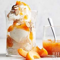 an ice cream sundae in a glass next to sliced peaches and a spoon