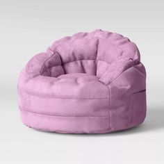 a pink bean bag chair sitting on top of a white floor