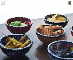 bowls filled with different types of food on top of a wooden table next to each other