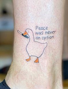 a tattoo on the leg of a person with a duck saying peace was never an option