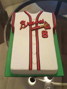 there is a cake that has been made to look like a baseball jersey on display