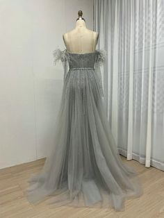 a dress on a mannequin in front of curtains