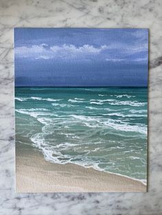 an ocean scene with waves crashing on the beach