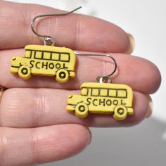 This listing is for one pair of lightweight school bus earrings.  Charm: (Measurement is from top of earwire to bottom of charm. The measurement may change slightly if you upgrade earwires.) * Plastic * School Bus - 27 mm long x 25 mm wide  Earwires: * The earwires are stainless steel and come with a clear back.  * I offer silver plated clip-on earrings and sterling silver hooks as well. Made from repurposed materials. Clear glue shows on the back. If you have any questions please send me a mess School Earrings, Bus Driver Appreciation, Teacher Earrings, Clear Back, Clear Glue, School Jewelry, Bugs And Insects, Bus Driver, Fun Earrings