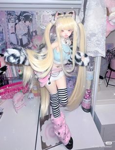 a doll with long blonde hair and black and white striped stockings is on display in a store