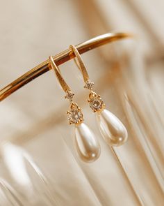 The French Pearl Drop earrings are a new favorite to the shop. Dreaming of weddings or an elegant sophisticated look, you are in luck! Luscious faux pearl drop with cubic zirconia and gold plated silver ear hook. All items come in a gift box ready to gift. To see more please visit  https://www.etsy.com/shop/BijouLimon Bijou Limon jewelry collections present a romantic French spin on the latest jewelry trends. Based on the US West Coast but French at heart, Bijou Limon interprets the current jewe Luxury Temple Style Pearl Earrings, Luxury Pearl Drop Gold-tone Earrings, Luxury Elegant Pearl Earrings In Brass, Luxury Yellow Gold Elegant Pearl Earrings, Luxury Elegant Yellow Gold Pearl Earrings, Elegant Bridal Earrings, Gold Pearl Earrings Dangle, Dangle Wedding Earrings, Gold Earrings Pearl