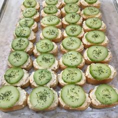 a tray filled with cucumber and cream cheese