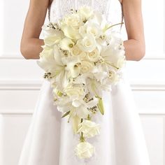 a bride holding a bouquet of white flowers