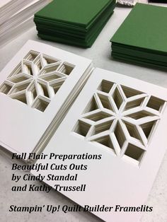 some cut outs sitting on top of a table next to green folders and papers