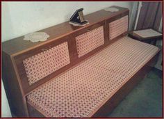 a wooden bench with an ironing board on it's back and side panels