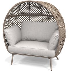 a wicker chair with two pillows on the back and one seat upholstered