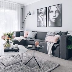 a living room filled with furniture and pictures on the wall above it's coffee table