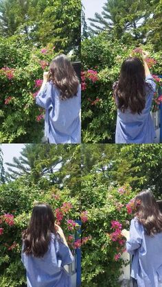 the woman is standing in front of some flowers