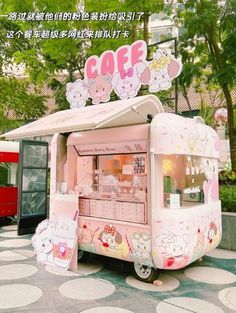 an ice cream cart with hello kitty decorations on top