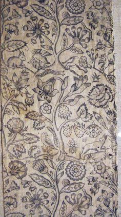 an old piece of cloth with flowers and leaves on it