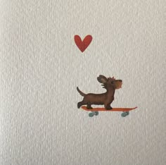 a small dog riding on top of a skateboard with a heart shaped balloon above it