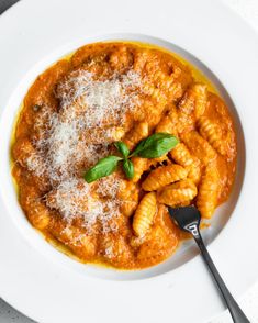 a white plate topped with pasta and sauce