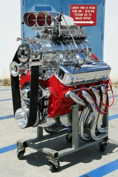 an engine is shown on a stand in front of a blue box and white wall