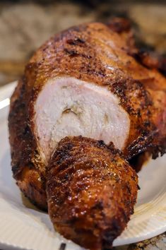 a piece of meat sitting on top of a white plate