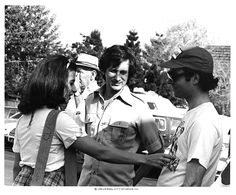 a group of people standing around each other