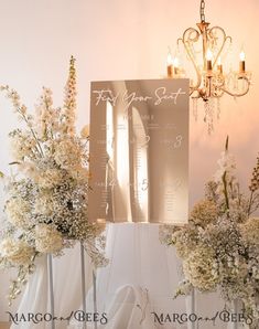 flowers are in vases next to a sign with the names of their wedding guests