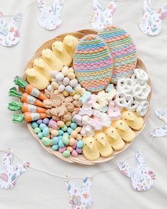 a basket filled with lots of different types of candies and cookies on top of a table