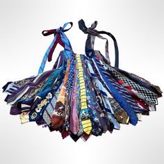 a bunch of ties that are sitting on top of each other in front of a white background