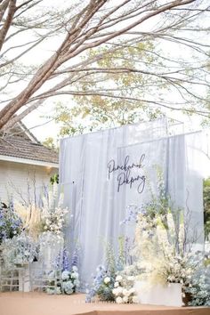 an outdoor ceremony setup with flowers and greenery