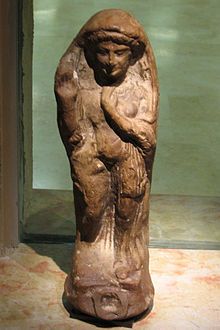 a stone statue sitting on top of a table