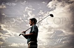 a young man holding a golf club under a cloudy sky