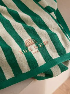 a green and white striped towel sitting on top of a counter