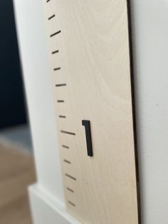 a close up view of a wooden ruler on a white surface with wood grained edges