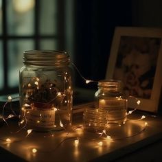 jars filled with candles and lights on top of a table