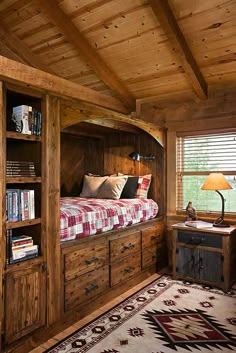 a bed in a room with wooden walls