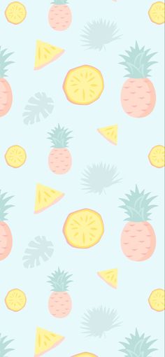 pineapples, oranges and lemon slices on a light blue background with green leaves